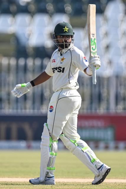 Pakistan's Babar Azam celebrates after scoring a half-century (50 runs) during the fourth day of the second Test cricket match between Pakistan and South Africa at the Rawalpindi Cricket Stadium in Rawalpindi on October 23, 2025. (Photo by Aamir QURESHI / AFP)