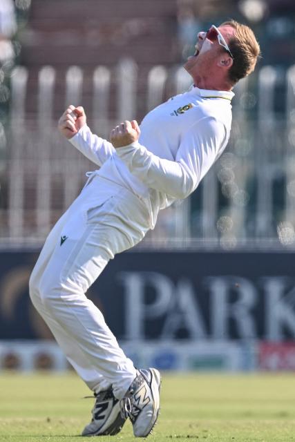South Africa's Simon Harmer celebrates after taking the wicekt of Pakistan's Babar Azam during the fourth day of the second Test cricket match between Pakistan and South Africa at the Rawalpindi Cricket Stadium in Rawalpindi on October 23, 2025. (Photo by Aamir QURESHI / AFP)