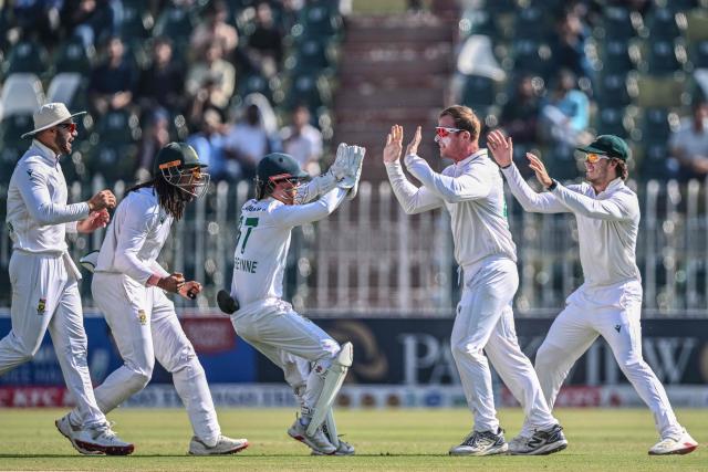 South Africa's Simon Harmer (2R) celebrates with teammates after taking the wicekt of Pakistan's Babar Azam during the fourth day of the second Test cricket match between Pakistan and South Africa at the Rawalpindi Cricket Stadium in Rawalpindi on October 23, 2025. (Photo by Aamir QURESHI / AFP)