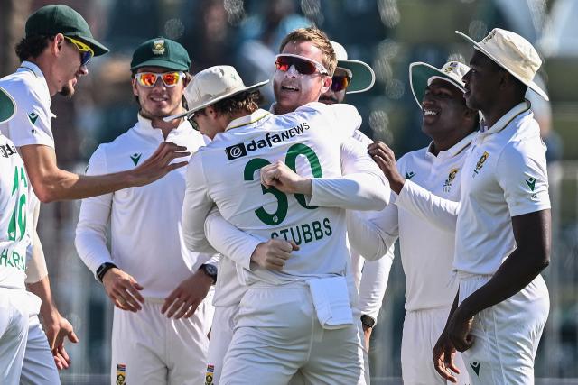South Africa's Simon Harmer (3R) celebrates with teammates after taking the wicekt of Pakistan's Babar Azam during the fourth day of the second Test cricket match between Pakistan and South Africa at the Rawalpindi Cricket Stadium in Rawalpindi on October 23, 2025. (Photo by Aamir QURESHI / AFP)