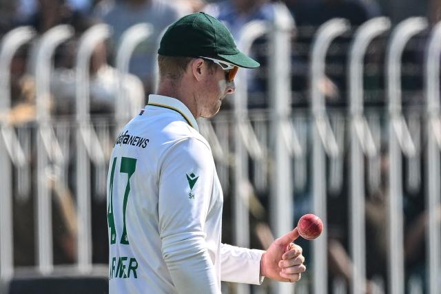 South Africa's Simon Harmer walks off the field after taking a five-wicket haul at the end of Pakistan's second inning during the fourth day of the second Test cricket match between Pakistan and South Africa at the Rawalpindi Cricket Stadium in Rawalpindi on October 23, 2025. (Photo by Aamir QURESHI / AFP)