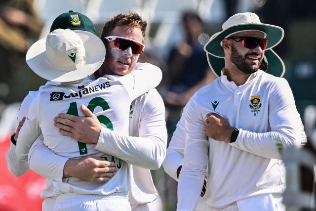 South Africa's Simon Harmer (C) celebrates with teammates after taking the wicket of Pakistan's Noman Ali during the fourth day of the second Test cricket match between Pakistan and South Africa at the Rawalpindi Cricket Stadium in Rawalpindi on October 23, 2025. (Photo by Aamir QURESHI / AFP)
