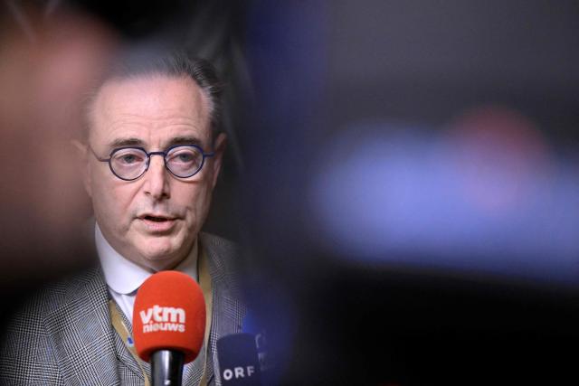 Belgium's Prime Minister Bart De Wever talks to the press as he arrives for a European Council meeting gathering the 27 EU leaders to discuss Ukraine, European defence, recent developments in the Middle East, competitiveness, housing and migration, in Brussels on October 23, 2025. (Photo by JOHN THYS / AFP)