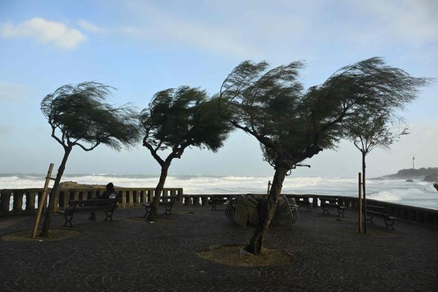 A man looks at the sea near the 'Grande Plage', as storm Benjamin hits the region, in Biarritz, south-western France on October 23, 2025. Winds gusted at over 100 km/h across much of France on October 23, 2025 morning as autumn storm Benjamin swept through the country. Meteo France classified the storm as "severe" and issued an orange alert for 19 departments. (Photo by Gaizka IROZ / AFP)