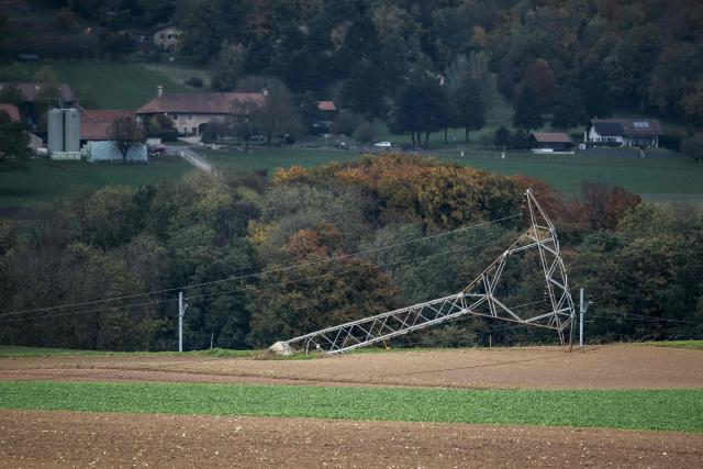 An electricity pylon is seen on the ground after being knocked down by strong winds during the autumn storm, Benjamin, which swept through Switzerland, near Biere on October 23, 2025. (Photo by Fabrice COFFRINI / AFP)