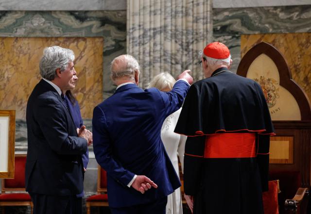 King Charles, with Queen Camilla, attend the ceremony of his appointment as Royal Confrater of St. Paul at the Basilica of Saint Paul Outside the Walls, in Rome, Italy, 23 October 2025. (Photo by GIUSEPPE LAMI / POOL / AFP)