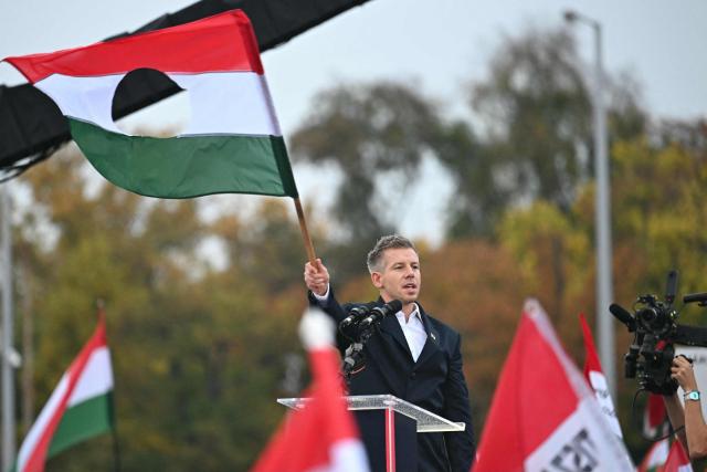 Leader of the opposition party TISZA (Respect and Freedom) Peter Magyar addresses participants near Heroes' Square in central Budapest on October 23, 2025, during an event commemorating the 69th anniversary of the Hungarian uprising against the Soviet occupation in 1956. Tens of thousands of Hungarians gathered in Budapest on Thursday at rival rallies, as the government and the opposition each look to drum up support ahead of tense elections next year. (Photo by Attila KISBENEDEK / AFP)