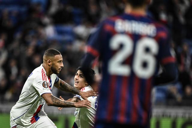 Lyon's French midfielder #08 Corentin Tolisso (L) celebrates after scoring his team's first goal during the UEFA Europa League 1st round day 3 football match between Olympique Lyonnais (OL) and FC Basel at the Groupama Stadium in Decines-Charpieu, central-eastern France on October 23, 2025. (Photo by JEFF PACHOUD / AFP)