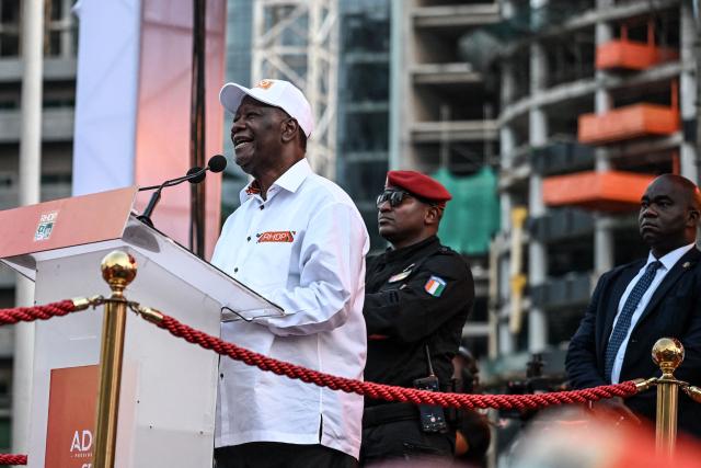 Ivorian President and presidential candidate for the Rally of Houphouetists for Democracy and Peace (RHDP), Alassane Ouattara (C) speaks during his closing campaign rally for the presidential election at the Place de la Republique, in the business district of Abidjan on October 23, 2025. The presidential election is scheduled for October 25, 2025. (Photo by Sia KAMBOU / AFP)