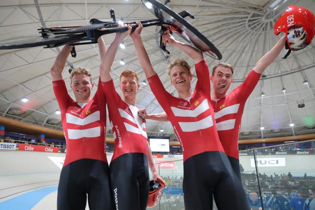 Denmark's  #13 Tobias Hansen, #14 Niklas Larsen, Frederik Madsen and Rasmus Perdersen celebrate after winning the gold medal in the men's team pursuit final event of the 2025 UCI Track World Championships at the Penalolen Velodrome, in Santiago, on October 23, 2025. (Photo by Javier TORRES / AFP)