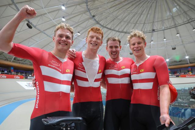 Denmark's  #13 Tobias Hansen, #14 Niklas Larsen, Frederik Madsen and Rasmus Perdersen celebrate after winning the gold medal in the men's team pursuit final event of the 2025 UCI Track World Championships at the Penalolen Velodrome, in Santiago, on October 23, 2025. (Photo by Javier TORRES / AFP)