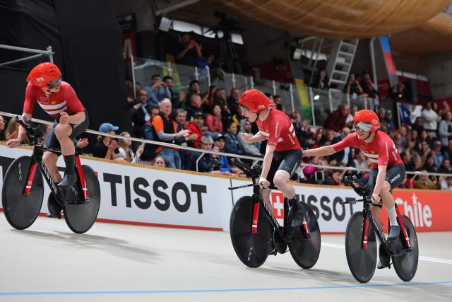Denmark's  #13 Tobias Hansen and #14 Niklas Larsen celebrate after winning the gold medal in the men's team pursuit final event of the 2025 UCI Track World Championships at the Penalolen Velodrome, in Santiago, on October 23, 2025. (Photo by Javier TORRES / AFP)