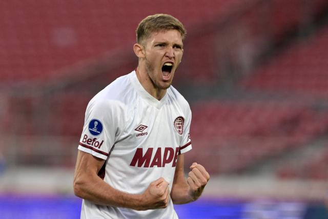 Lanus' midfielder #19 Rodrigo Castillo celebrates scoring his team's first goal during the Copa Sudamericana semifinal first leg football match between Chile's Universidad de Chile and Argentina's Lanus at the Nacional Julio Martinez Pradanos stadium in Santiago on October 23, 2025. (Photo by Rodrigo ARANGUA / AFP)