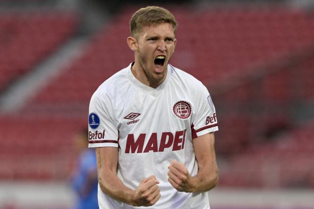 Lanus' midfielder #19 Rodrigo Castillo celebrates scoring his team's first goal during the Copa Sudamericana semifinal first leg football match between Chile's Universidad de Chile and Argentina's Lanus at the Nacional Julio Martinez Pradanos stadium in Santiago on October 23, 2025. (Photo by Rodrigo ARANGUA / AFP)