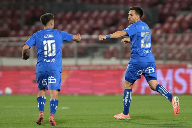 Universidad de Chile's forward #10 Lucas Assadi and teammate defender #22 Matias Zaldivia celebrate the first goal of their team during the Copa Sudamericana semifinal first leg football match between Chile's Universidad de Chile and Argentina's Lanus at the Nacional Julio Martinez Pradanos stadium in Santiago on October 23, 2025. (Photo by Rodrigo ARANGUA / AFP)