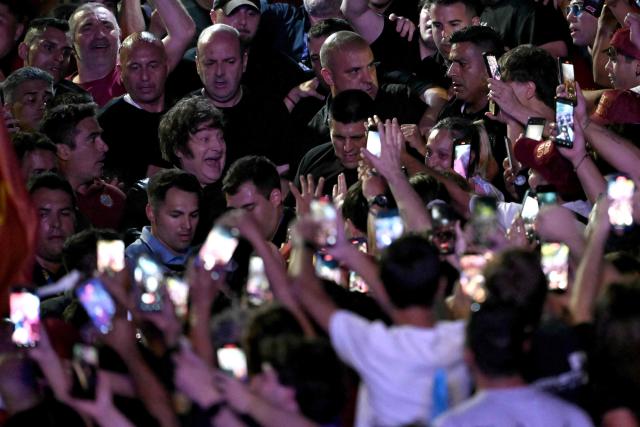 Argentina's President Javier Milei (2nd-L) greets supporters during the closing campaign rally of Libertad Avanza party ahead of the upcoming legislative elections in Rosario, Santa Fe province, Argentina on October 23, 2025. Milei, once a global poster boy for budget-slashing libertarian politics, is heading into the polls diminished by his failure to stabilize Argentina's ailing peso despite spending nearly all the Central Bank's dollar reserves to prop it up. (Photo by Luis ROBAYO / AFP)