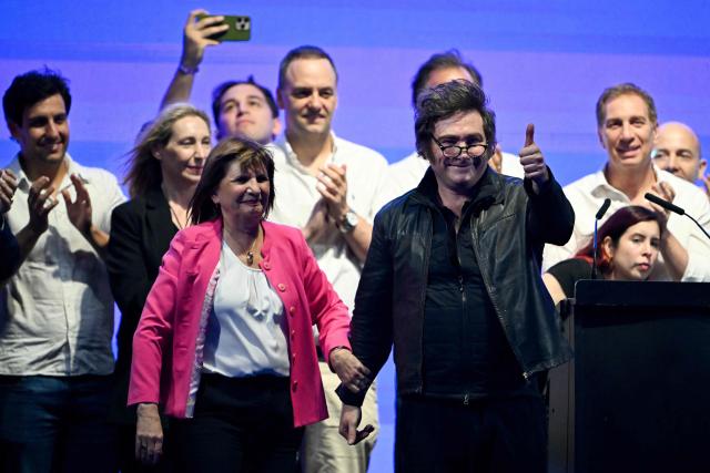 Argentina's President Javier Milei (R) gives a thumbs up with Security Minister Patricia Bullrich (L) during the closing campaign rally of Libertad Avanza party ahead of the upcoming legislative elections in Rosario, Santa Fe province, Argentina on October 23, 2025. Milei, once a global poster boy for budget-slashing libertarian politics, is heading into the polls diminished by his failure to stabilize Argentina's ailing peso despite spending nearly all the Central Bank's dollar reserves to prop it up. (Photo by Luis ROBAYO / AFP)