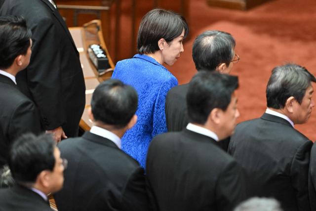 Japan's Prime Minister Sanae Takaichi (top, C) attends the opening ceremony of the extraordinary Diet session in Tokyo on October 24, 2025. (Photo by Kazuhiro NOGI / AFP)