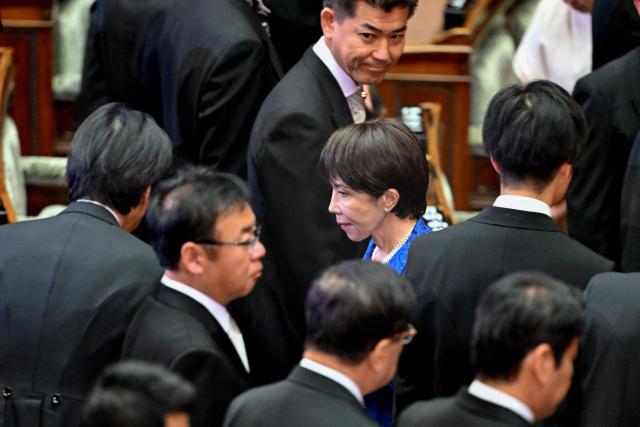 Japan's Prime Minister Sanae Takaichi (C) leaves after attending the opening ceremony of the extraordinary Diet session in Tokyo on October 24, 2025. (Photo by Kazuhiro NOGI / AFP)