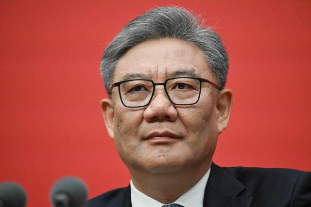 China’s Minister of Commerce Wang Wentao attends a press conference of the Central Committee of the Communist Party of China (CPC) in Beijing on October 24, 2025. (Photo by Pedro PARDO / AFP)