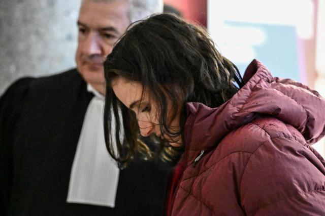 French biathlon champion Julia Simon (R), suspected of credit card fraud, stands next to her lawyer, Christian Borel, while she waits for her trial at the Albertville courthouse, on October 24, 2025. (Photo by JEAN-PHILIPPE KSIAZEK / AFP)