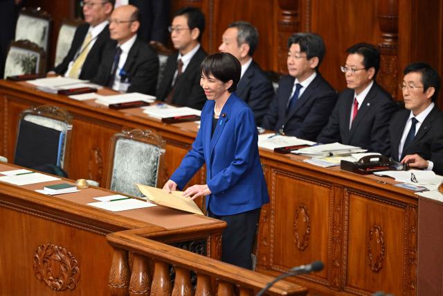 Japan's Prime Minister Sanae Takaichi takes her seat before delivering her policy speech in the House of Representatives plenary session in Tokyo on October 24, 2025. Japan's new prime minister Sanae Takaichi said on October 24 she would try to achieve the country's target of spending two percent of GDP on defence two years early. (Photo by Kazuhiro NOGI / AFP)