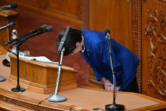Japan's Prime Minister Sanae Takaichi bows as she finishes her policy speech in the House of Representatives plenary session in Tokyo on October 24, 2025. Japan's new prime minister Sanae Takaichi said on October 24 she would try to achieve the country's target of spending two percent of GDP on defence two years early. (Photo by Kazuhiro NOGI / AFP)
