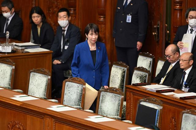 Japan's Prime Minister Sanae Takaichi (C) arrives for the House of Representatives plenary session to deliver her policy speech in Tokyo on October 24, 2025. Japan's new prime minister Sanae Takaichi said on October 24 she would try to achieve the country's target of spending two percent of GDP on defence two years early. (Photo by Kazuhiro NOGI / AFP)