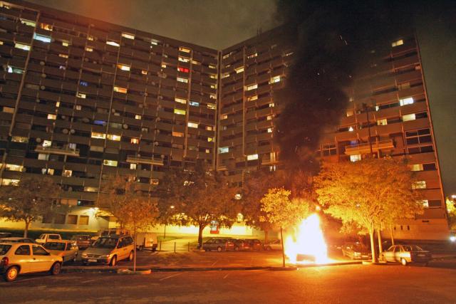 (FILES) A car set ablaze by rioters is burning, 09 November 2005 in "La Reynerie", a popular neighbourhood of Toulouse, south western France. On October 27, 2005, Zyed Benna and Bouna Traore, aged 17 and 15, died from electrocution in an EDF power substation where they had taken refuge after being chased by the police. This tragedy sparked a series of riots that spread from Clichy-sous-Bois to the rest of the country for three weeks, leading to the declaration of a state of emergency. (Photo by Georges GOBET / AFP)