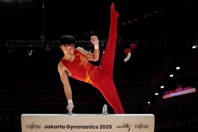 China’s Hong Yanming competes the men's pommel horse final at the 53rd FIG Artistic Gymnastics World Championships in Jakarta on October 24, 2025. (Photo by Yasuyoshi CHIBA / AFP)