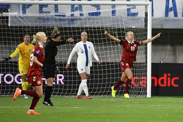 Denmark's Sofie Svava (L) and Pernille Harder (R) celebrate the 0-1 goal by Emma Snerle (unseen) during the UEFA Women's Nations League semi-final football match between Finland and Denmark in Tampere, Finland on October 24, 2025. (Photo by Antti Aimo-Koivisto / Lehtikuva / AFP) / Finland OUT