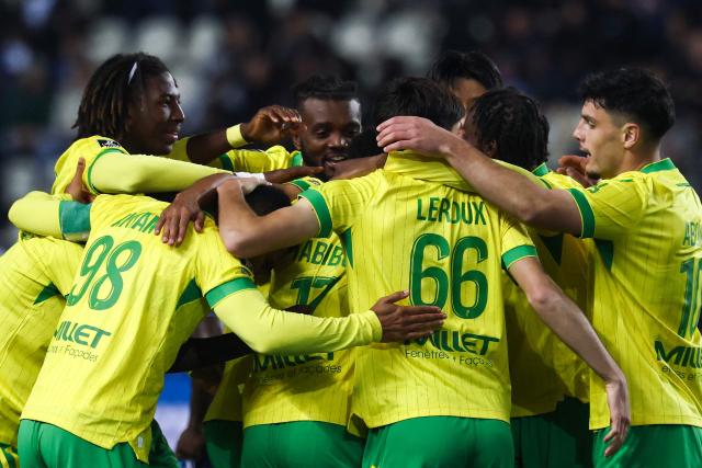 Nantes' players celebrate after scoring their team first goal during the French L1 football match between Paris FC and FC Nantes at the Stade Jean-Bouin in Paris on October 24, 2025. (Photo by FRANCK FIFE / AFP)