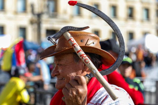 An elderly man attends a rally called by Colombia's President Gustavo Petro at Bolivar Square in Bogota on October 24, 2025. US on Friday announced sanctions on Colombia's President Gustavo Petro, who Washington has accused of failing to curb illicit drug trafficking, alongside his wife and eldest son. (Photo by John Vizcaino / AFP)