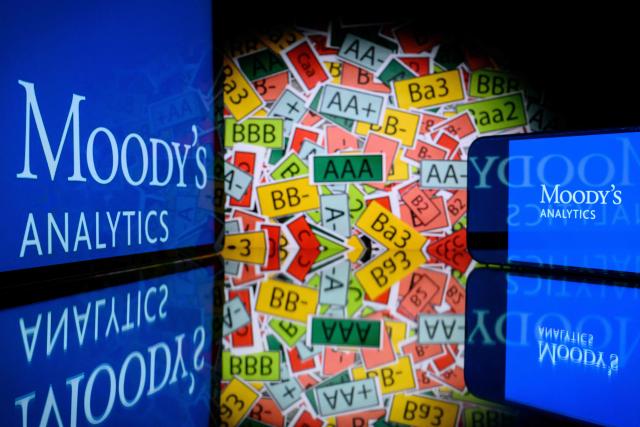 (FILES) This illustration photograph shows screens displaying the logo of the rating agency Moody's Analytics and signs of the ratings used by rating agencies, in Toulouse on March 18, 2025. On October 24, 2025, Moody's rating agency maintained France's sovereign rating, while lowering the outlook from "stable" to "negative", thereby issuing a warning to the country in the midst of the budget debate in parliament. (Photo by Lionel BONAVENTURE / AFP)
