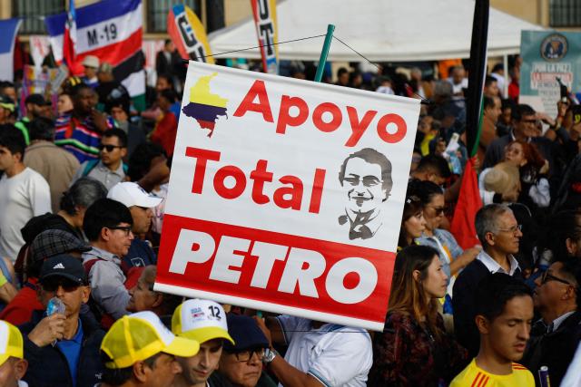 A demonstrator holds banner backing Colombia's President Gustavo Petro during a rally in his support at Bolivar Square in Bogota on October 24, 2025. US on Friday announced sanctions on Colombia's President Gustavo Petro, who Washington has accused of failing to curb illicit drug trafficking, alongside his wife and eldest son. (Photo by John Vizcaino / AFP)