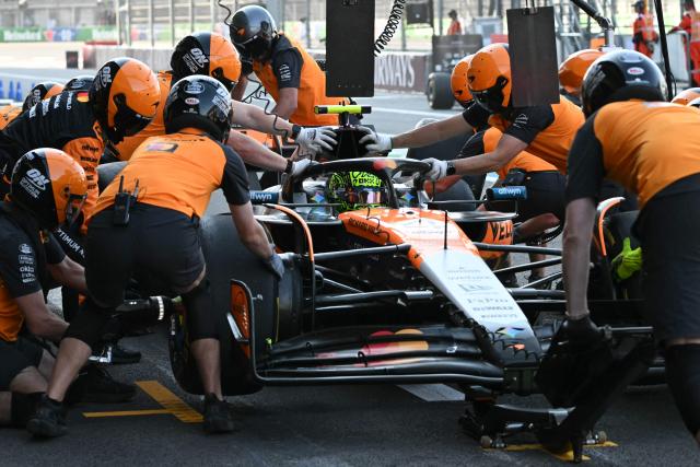 McLaren's mechanics move the car of British driver Lando Norris from pit lane to the garage during the second practice session of the Mexico City Formula One Grand Prix at the Hermanos Rodriguez racetrack in Mexico City on October 24, 2025. (Photo by Yuri CORTEZ / AFP)