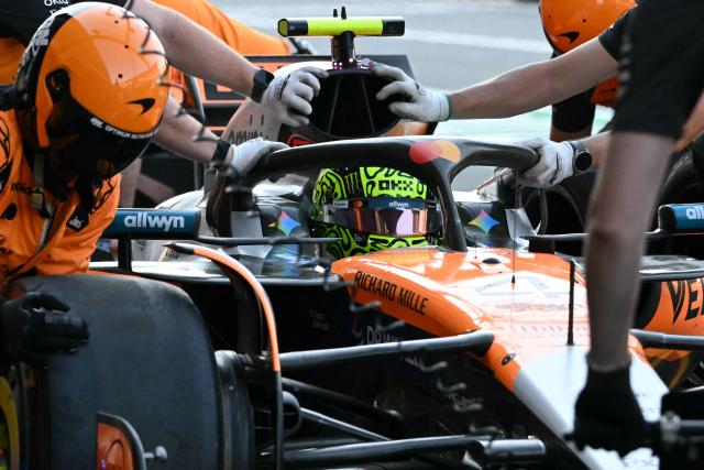 McLaren's mechanics move the car of British driver Lando Norris from pit lane to the garage during the second practice session of the Mexico City Formula One Grand Prix at the Hermanos Rodriguez racetrack in Mexico City on October 24, 2025. (Photo by Yuri CORTEZ / AFP)