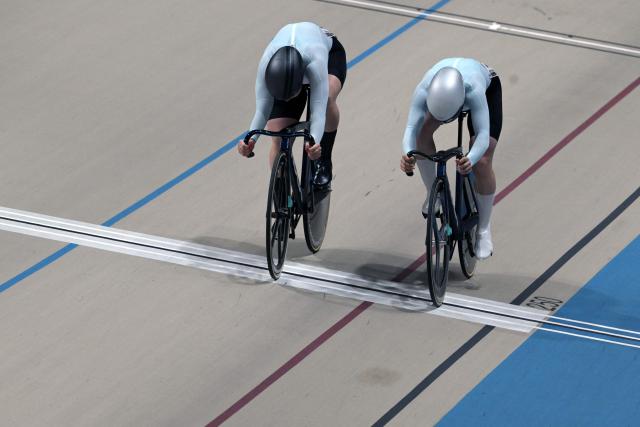 AIN's #57 Iana Burlakova and #59 Alina Lysenko compete in the women's sprint event final at the 2025 UCI Track World Championships, in the Penalolen Velodrome in Santiago, on October 24, 2025. (Photo by Rodrigo ARANGUA / AFP)
