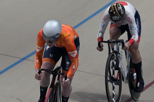 Japan's #116 Mina Sato and Netherlands' #122 Hetty Van de Wouw compete in the women's sprint event final at the 2025 UCI Track World Championships, in the Penalolen Velodrome in Santiago, on October 24, 2025. (Photo by Rodrigo ARANGUA / AFP)
