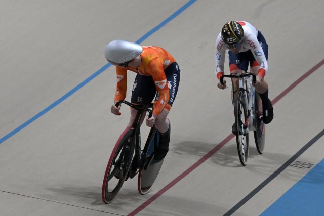 Japan's #116 Mina Sato and Netherlands' #122 Hetty Van de Wouw compete in the women's sprint event final at the 2025 UCI Track World Championships, in the Penalolen Velodrome in Santiago, on October 24, 2025. (Photo by Rodrigo ARANGUA / AFP)