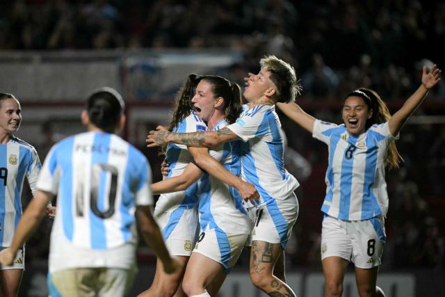 Argentina's defender #06 Aldana Cometti (C) celebrates with teammates after scoring her team's first goal during the Conmebol Women's Nations League 2025-26 football match between Argentina and Paraguay at the Diego Armando Maradona Stadium in Buenos Aires on October 24, 2025. (Photo by JUAN MABROMATA / AFP)