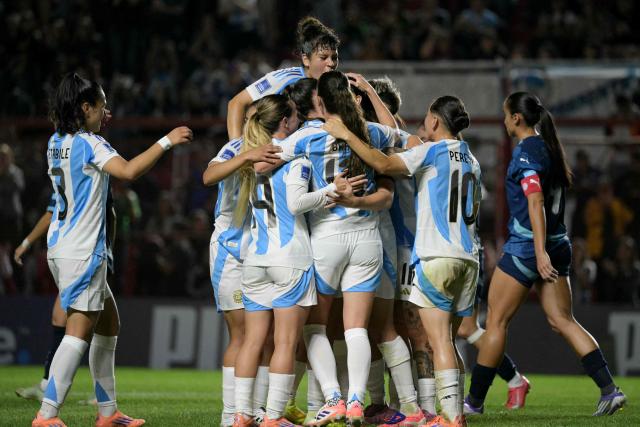 Argentina's defender #06 Aldana Cometti (unseen) celebrates with teammates after scoring her team's first goal during the Conmebol Women's Nations League 2025-26 football match between Argentina and Paraguay at the Diego Armando Maradona Stadium in Buenos Aires on October 24, 2025. (Photo by JUAN MABROMATA / AFP)