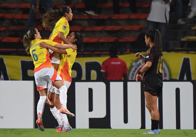 Colombia's midfielder #10 Leicy Santos (top) celebrates with teammates after scoring her team's third goal during the Conmebol Women's Nations League 2025-26 football match between Colombia and Peru at the Atanasio Girardot Stadium in Medellin, Colombia on October 24, 2025. (Photo by Jaime SALDARRIAGA / AFP)