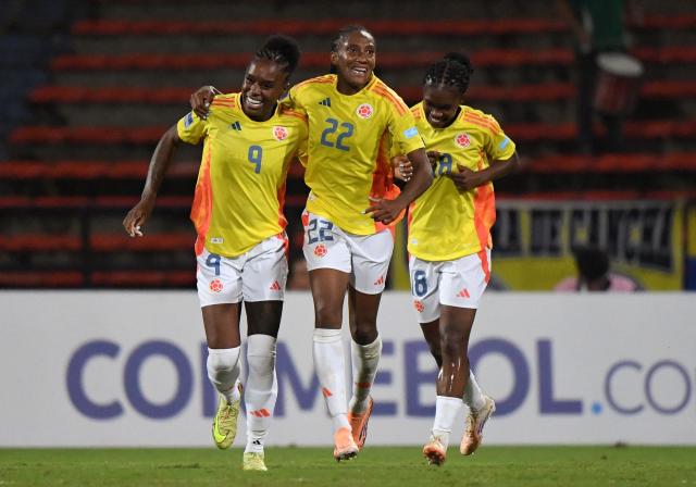 Colombia's forward #09 Ivone Chacon celebrates after scoring her team's fourth goal with teammates forwards #22 Daniela Caracas and #18 Linda Caicedo during the Conmebol Women's Nations League 2025-26 football match between Colombia and Peru at the Atanasio Girardot Stadium in Medellin, Colombia on October 24, 2025. (Photo by Jaime SALDARRIAGA / AFP)
