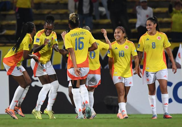 Colombia's forward #09 Ivone Chacon celebrates with teammates after scoring her team's fourth goal during the Conmebol Women's Nations League 2025-26 football match between Colombia and Peru at the Atanasio Girardot Stadium in Medellin, Colombia on October 24, 2025. (Photo by Jaime SALDARRIAGA / AFP)