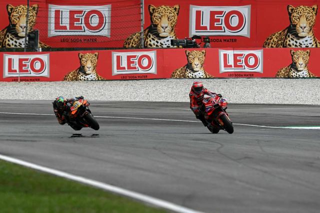 Ducati Lenovo Team's Italian MotoGP rider Michele Pirro (R) and Red Bull KTM Factory Racing team's South African MotoGp rider Brad Binder (L) ride during the qualifying session of the MotoGP Malaysian Grand Prix at the Sepang International Circuit in Sepang on October 25, 2025. (Photo by Lillian SUWANRUMPHA / AFP)