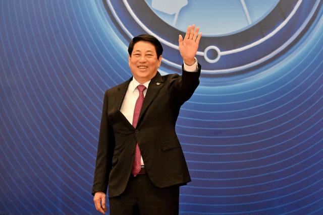 Vietnam's President Luong Cuong waves at the signing ceremony of the United Nations Convention against Cybercrime at the National Convention Center in Hanoi on October 25, 2025. (Photo by Nhac NGUYEN / AFP)