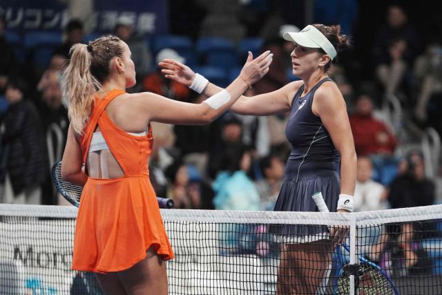 Switzerland's Belinda Bencic (R) and USA's Sofia Kenin approach each other for a hug after their women's singles semi-finals at the Pan Pacific Open tennis tournament in Tokyo on October 25, 2025. (Photo by Kazuhiro NOGI / AFP)