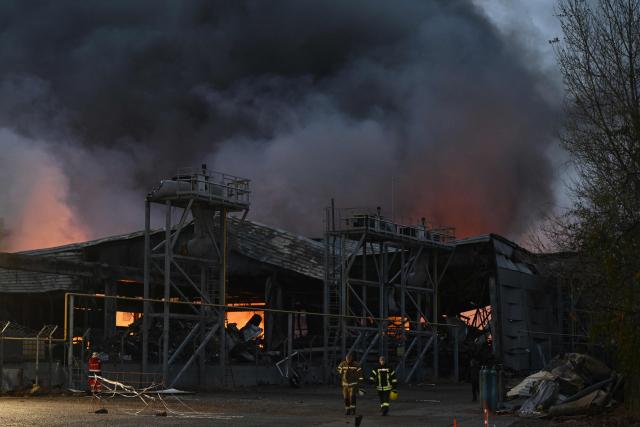 Ukrainian firefighters extinguish a fire at the site of a food warehouse following a Russian missile strike in Kyiv early on October 25, 2025, amid the Russian invasion of Ukraine. (Photo by Genya SAVILOV / AFP)