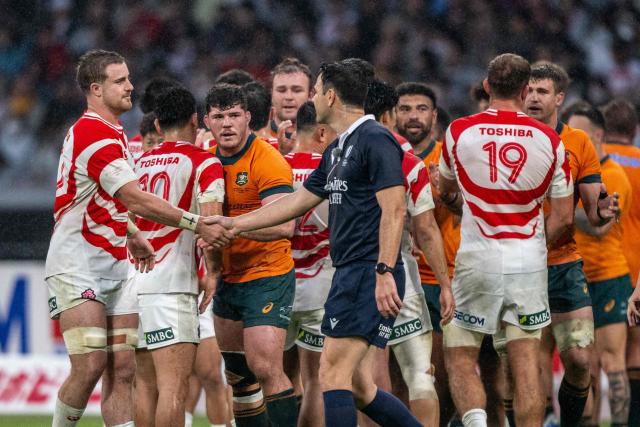 Japan and Australia players shake hands after the international rugby union Test match between Japan and Australia at the National Stadium in Tokyo on October 25, 2025. (Photo by Philip FONG / AFP)